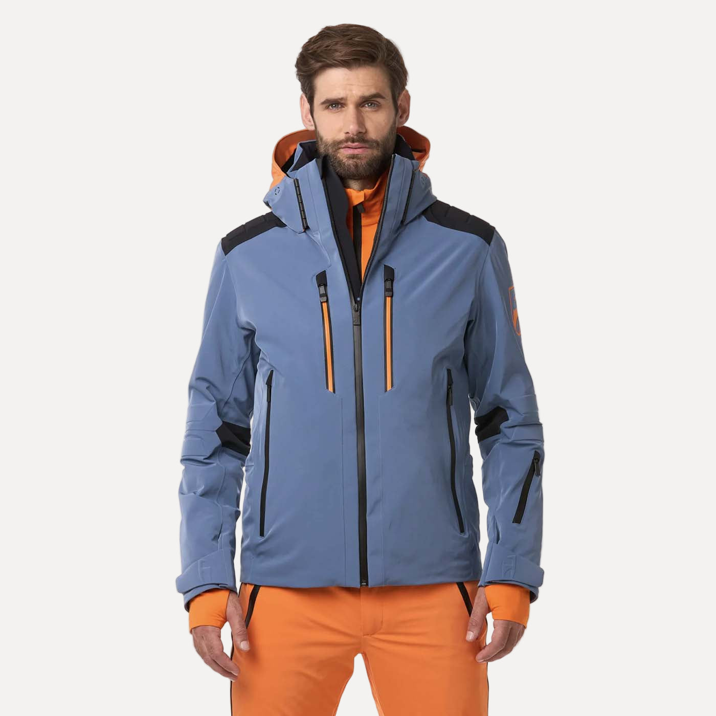 Man wearing a blue and orange jacket with a white background